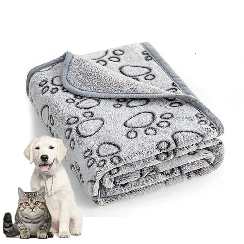 Gray pet blanket with paw prints, shown with a dog and cat on a white background.