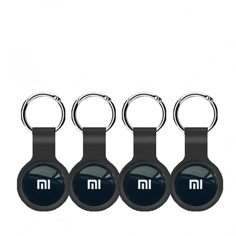 Four black Mi keychain devices with the Mi logo on a white background.